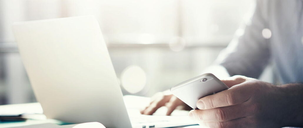 Businessman,Working,With,Generic,Design,Notebook.,Holding,Smartphone,In,Hands. Businessman,Working,With,Generic,Design,Notebook.,Holding,Smartphone,In,Hands.